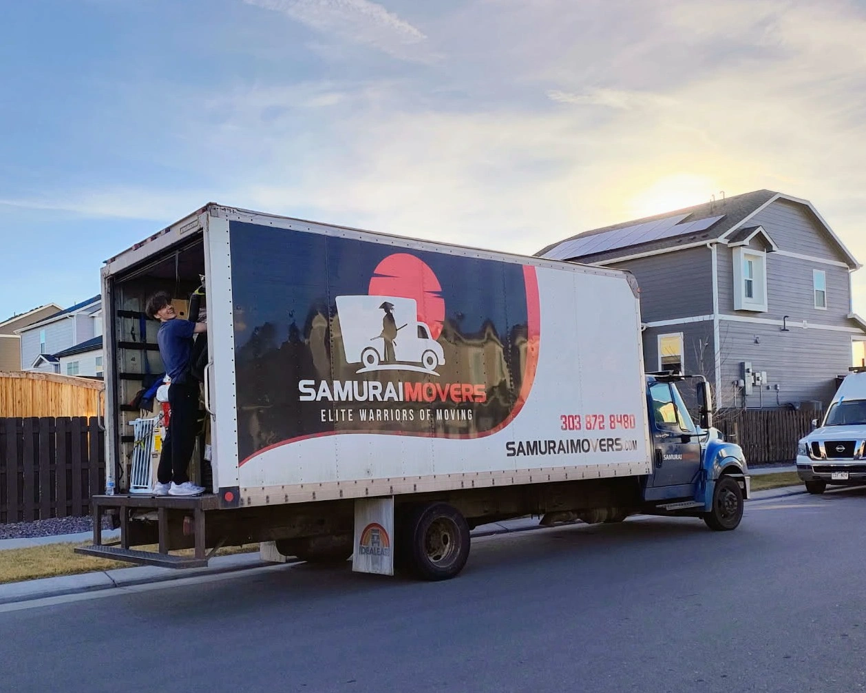 Moving truck with Samurai Movers logo and crew preparing for a move.