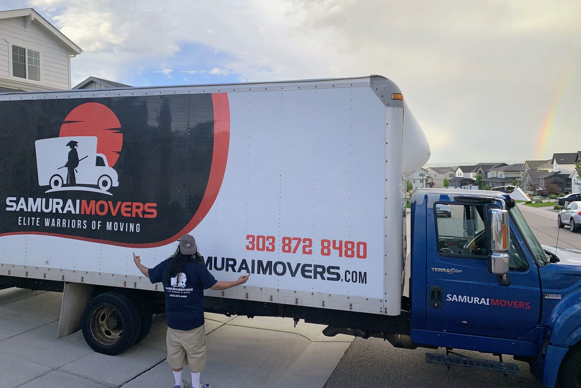 Samurai Movers truck with logo and contact info in driveway.