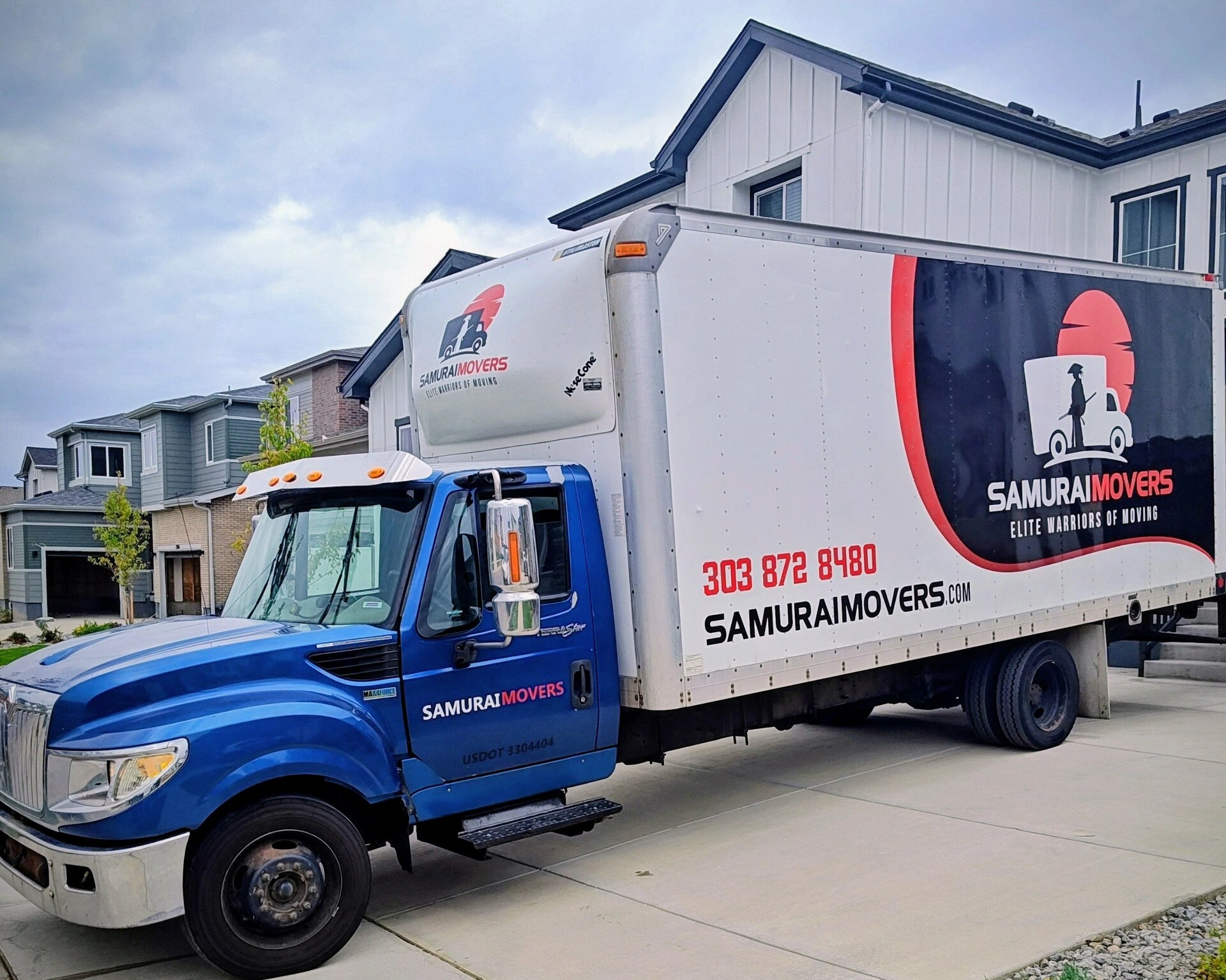 Samurai Movers truck parked outside a newly built Colorado home before loading